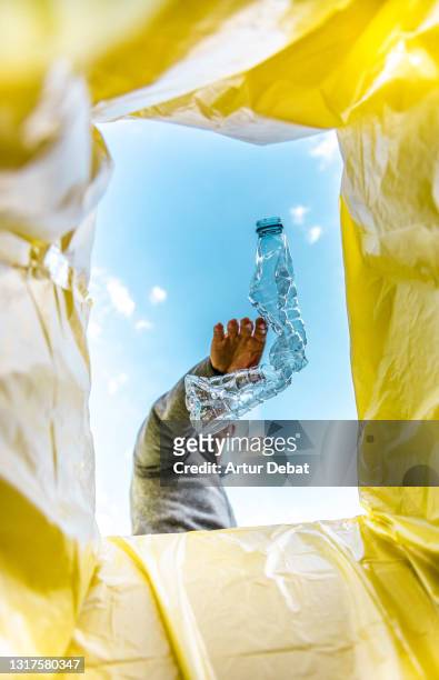 recycling single use plastic bottle with creative view from inside the bin. - recycled stock pictures, royalty-free photos & images