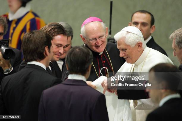 Manuele Malenotti and Michele Malenotti, owners of Belstaff, give a white jacket as a gift to Pope Benedict XVI during the weekly audience at the...