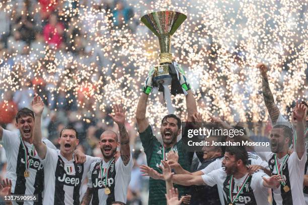 Gianluigi Buffon of Juventus lifts the Scudetto during the trophy presentation following the serie A match between Juventus and Hellas Verona FC at...