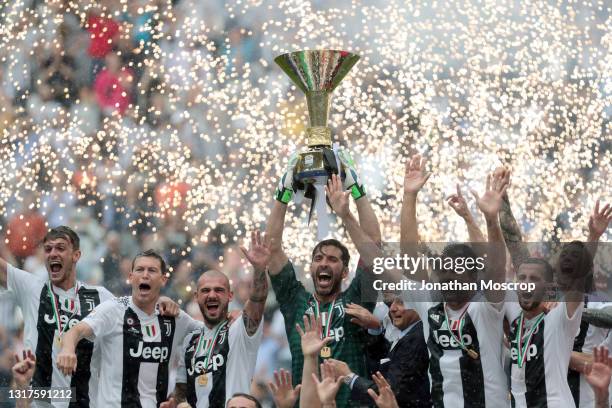 Gianluigi Buffon of Juventus lifts the Scudetto during the trophy presentation following the serie A match between Juventus and Hellas Verona FC at...