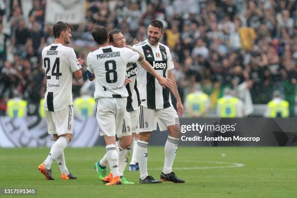Stephan Lichtsteiner of Juventus is embraced by team mate Claudio Marchisio as Daniele Rugani and Andrea Barzagli look on following his final game...