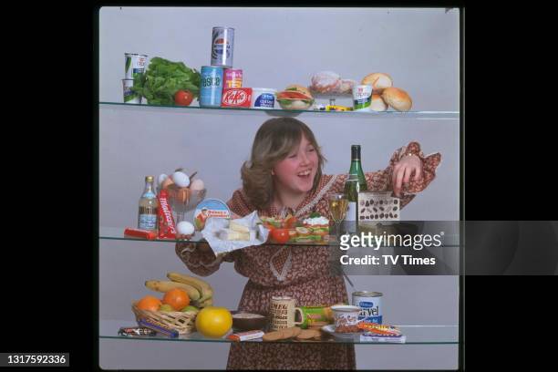 Actress Pauline Quirke photographed among shelves of food and drink, circa 1978.