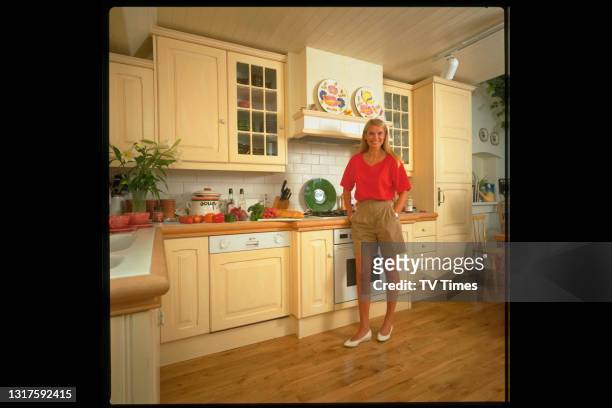 Television presenter Anneka Rice photographed at home in her kitchen, circa 1991.