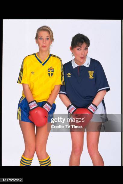 Television presenters Lorraine Kelly and Ulrika Jonsson posed with boxing gloves and football jerseys , circa June, 1990.