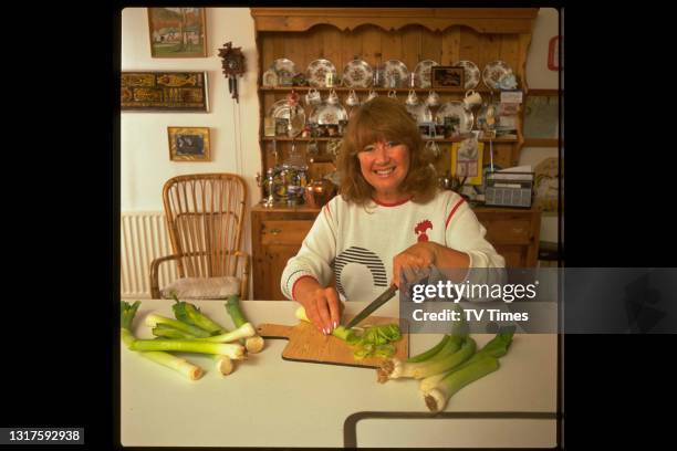 Actress Nerys Hughes photographed cooking at home, circa 1988.