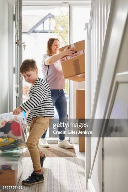 mother and young son moving house - welcome mat stock pictures, royalty-free photos & images