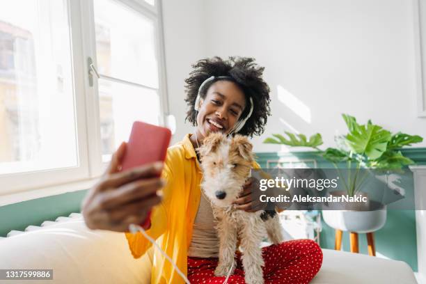 joven y su perro en una videollamada - animal call fotografías e imágenes de stock