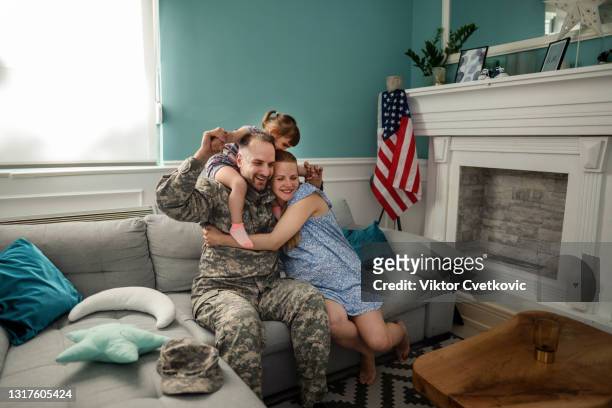 happy military family enjoying in time together at home. - military veteran armed forces stock pictures, royalty-free photos & images