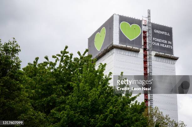 The covered structure of Grenfell Tower is seen above a nearby housing estate on May 12, 2021 in London, England. The Ministry of Housing Communities...