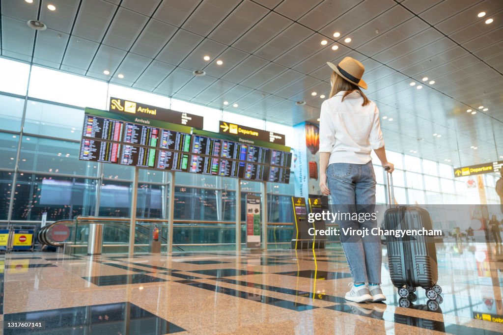 Rear tourist woman at international airport