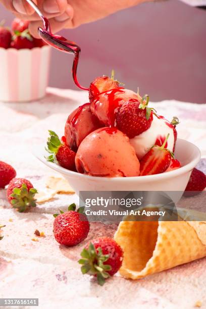 a hand is putting down shouroup with spoon to strawberry icecream food styling for social media food trend photo - mulberry fruit stock pictures, royalty-free photos & images