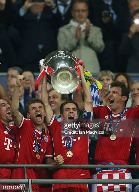 Philipp Lahm of Bayern Muenchen hold the trophy after winning the UEFA Champions League final match against Borussia Dortmund at Wembley Stadium on...