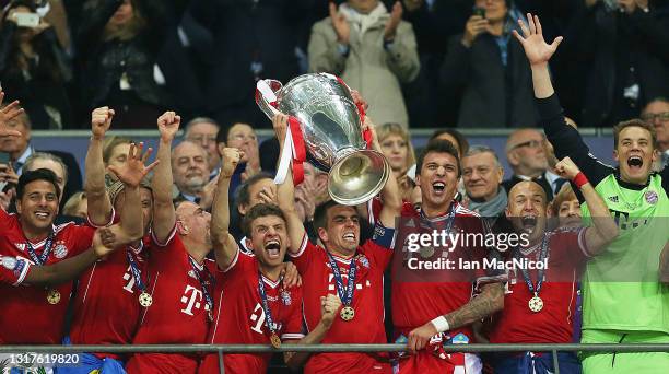 Philipp Lahm of Bayern Muenchen hold the trophy after winning the UEFA Champions League final match against Borussia Dortmund at Wembley Stadium on...