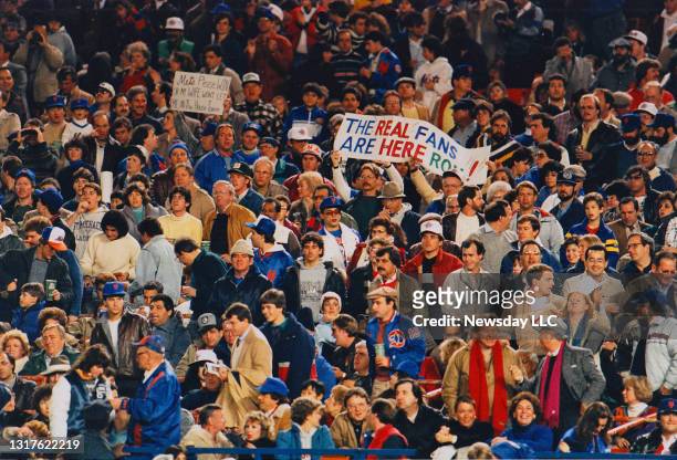 The crowd of fans roots for the Mets at Shea Stadium in Flushing, New York on October 25 in game 6 of the World Series against the Boston Red Sox....