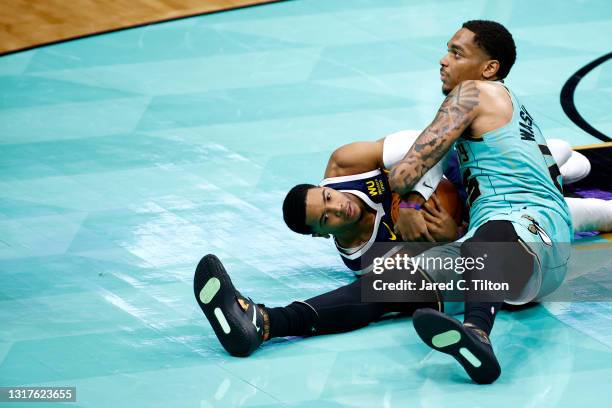 Washington of the Charlotte Hornets and Shaquille Harrison of the Denver Nuggets battle for possession during the fourth quarter of their game at...