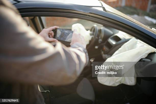 car insurance agent at work by the crashed car - car insurance agent stock pictures, royalty-free photos & images