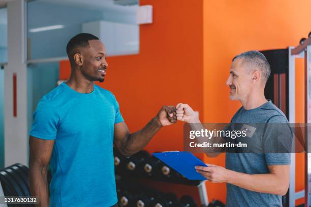 sports training in the gym with personal trainer - gym reopening stock pictures, royalty-free photos & images