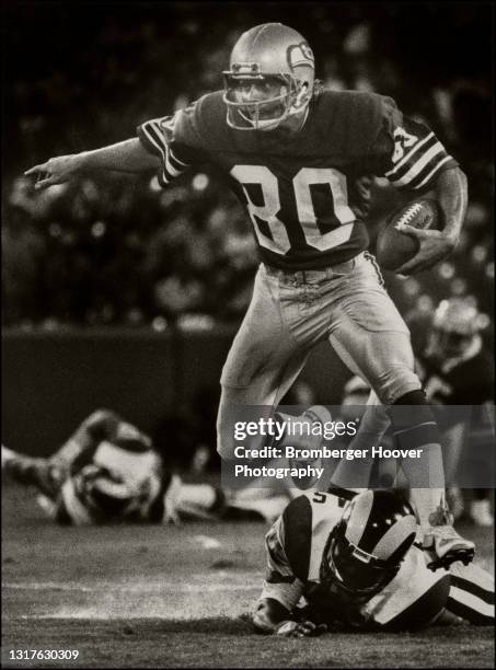 View of American football player Steve Largent, of the Seattle Seahawks, runs with the ball during a pre-season game against the Los Angeles Rams,...