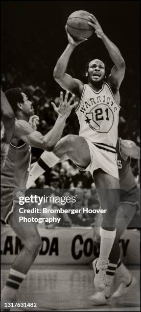 View of American basketball player World B Free , of the Golden State Warriors, jumps with the ball during a game against the Philadelphia 76ers,...