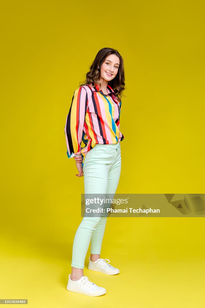 Happy Teen girl in front of plain background