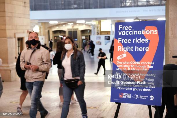 People walk through Grand Central Terminal where a pop-up site for COVID-19 vaccinations opened on May 12, 2021 in New York City. The pop-up site is...