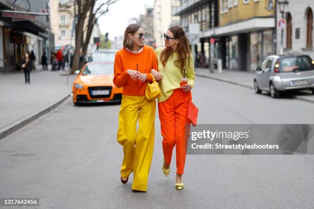 Influencer Annette Weber wearing an orange pullover by Allude, yellow wide leg pants by Max Mara, brown sandals by Saint Laurent, a yellow bag by...