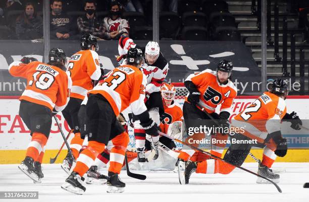 Miles Wood of the New Jersey Devils screens Brian Elliott of the Philadelphia Flyers as the Flyers defend the net at the Wells Fargo Center on May...