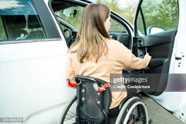 young disabled woman - car ownership. - wheelchair ramp stock pictures, royalty-free photos & images