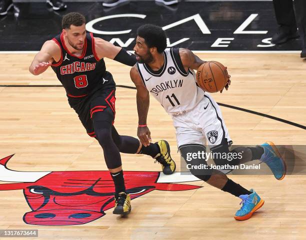 Kyrie Irving of the Brooklyn Nets drives against Zach LaVine of the Chicago Bulls at the United Center on May 11, 2021 in Chicago, Illinois. The Nets...