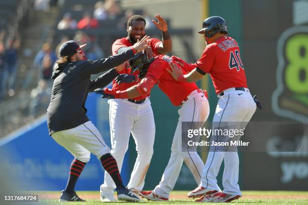 Austin Hedges, Franmil Reyes and Harold Ramirez celebrate with Amed Rosario of the Cleveland after he hit a walk-off RBI single in the tenth inning...