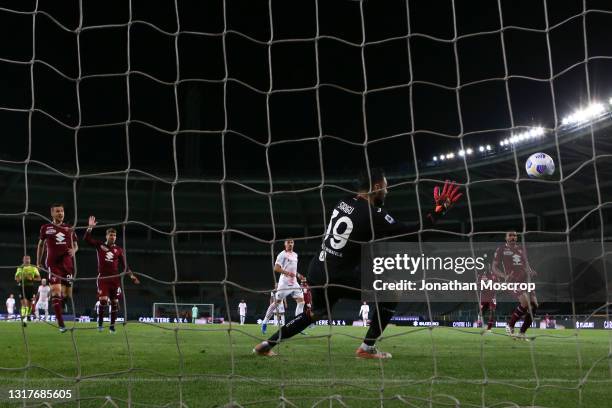 Salvatore Sirigu of Torino FC dives but in vain as Ante Rebic of AC Milan's strike finishes in the net to give the side a 5-0 lead during the Serie A...