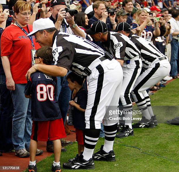 Officials pose with fans before the Cleveland Browns play the Houston Texans at Reliant Stadium on November 6, 2011 in Houston, Texas. Houston won...