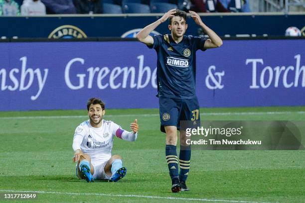 Gustavo Bou of the New England Revolution and Leon Flach of the Philadelphia Union react during the second half at Subaru Park on May 12, 2021 in...