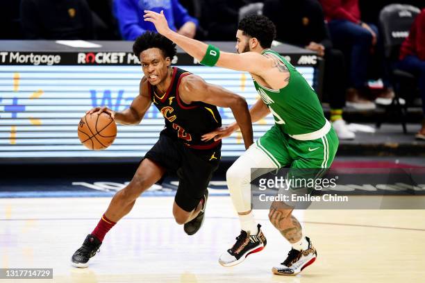 Collin Sexton of the Cleveland Cavaliers drives against Jayson Tatum of the Boston Celtics during the third quarter at Rocket Mortgage Fieldhouse on...