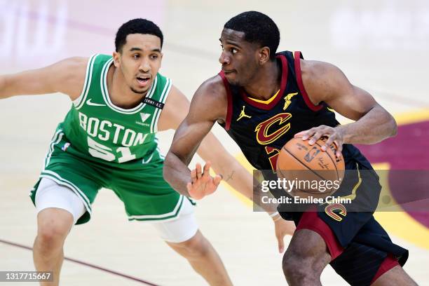 Damyean Dotson of the Cleveland Cavaliers drives against Tremont Waters of the Boston Celtics during the fourth quarter at Rocket Mortgage Fieldhouse...