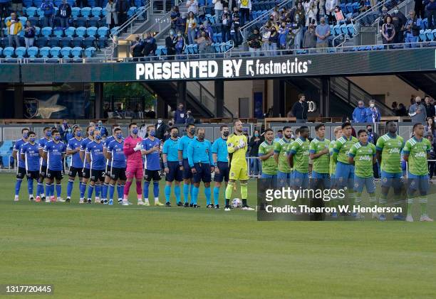 The Seattle Sounders and San Jose Earthquakes stand during the National Anthem prior to the start of their game at PayPal Park on May 12, 2021 in San...