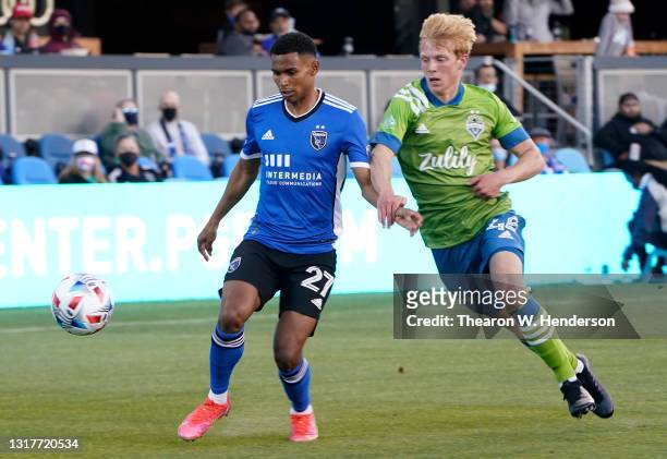 Marcos Lopez of San Jose Earthquakes grabs control of the ball defended by Ethan Dobbelaere of Seattle Sounders during the first half of their game...