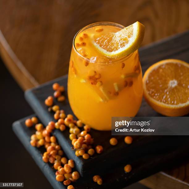 sea buckthorn and orange smoothie vitamin drink. glass of healthy fresh citrus and hippophae juice or soft drink. bright colors of nature - soft drink stock-fotos und bilder
