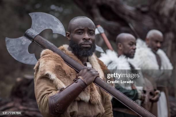 small group of african warriors in a forest - barbarian stock pictures, royalty-free photos & images