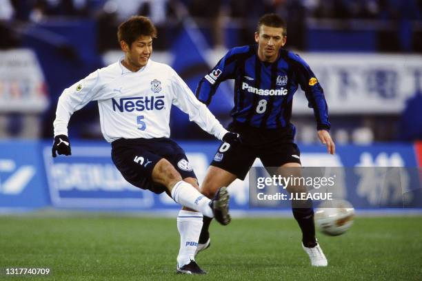 Makoto Tanaka of Jubilo Iwata controls the ball under pressure of Marcos Aurelio Galeano of Gamba Osaka during the J.League J1 first stage match...