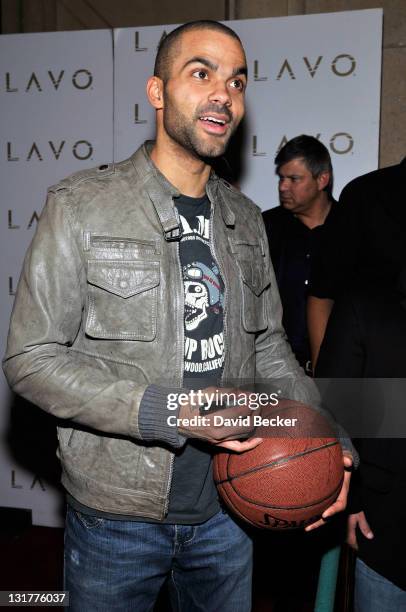 Player Tony Parker autographs a basketball after he arrived at the Baller's Ball at the Lavo Nightclub at The Palazzo on February 19, 2011 in Las...