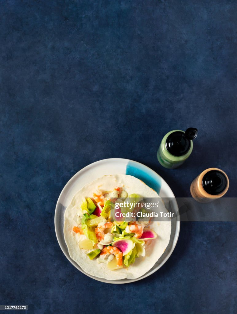 Shrimp tostada on blue background