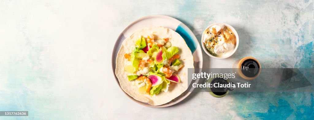 Shrimp tostada on blue background