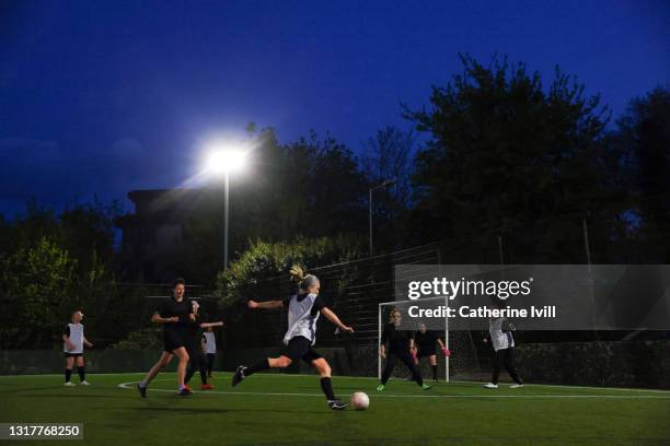 women play a competitive game of football - womens football stock pictures, royalty-free photos & images