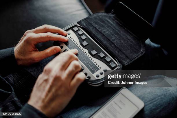man using braille keyboard - johner images bildbanksfoton och bilder