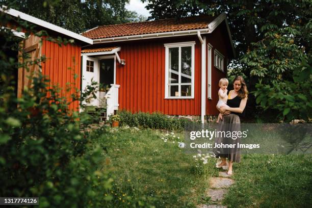 mother with baby in garden - scandinavian house outside stock pictures, royalty-free photos & images