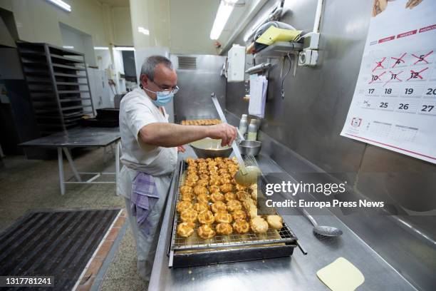 The pastry chef prepares the typical San Isidro doughnuts at Casa Mira, on May 13, 2021 in Madrid, Spain. The different types of donuts such as the...