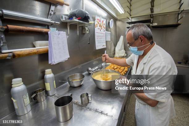 The pastry chef makes the dough for the typical San Isidro doughnuts at Casa Mira, on May 13, 2021 in Madrid, Spain. The different types of donuts...