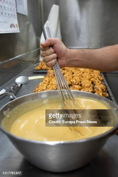 The pastry chef makes the dough for the typical San Isidro doughnuts at Casa Mira, on May 13, 2021 in Madrid, Spain. The different types of donuts...