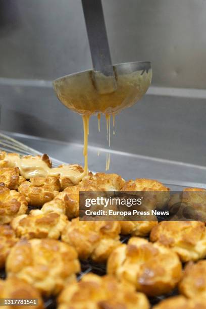 The pastry chef prepares the typical San Isidro doughnuts at Casa Mira, on May 13, 2021 in Madrid, Spain. The different types of donuts such as the...